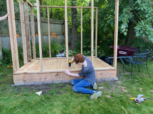 William learns to use a drill and L-shaped brackets while framing his house.